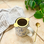 gold tea strainer top view